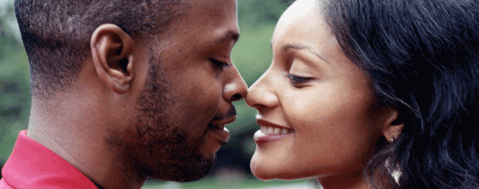 A young adult couple faces together