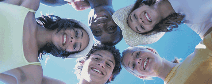 Young adults in a circle with their heads together