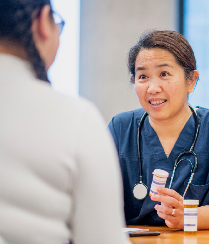 A health care provider talking to a teen patient