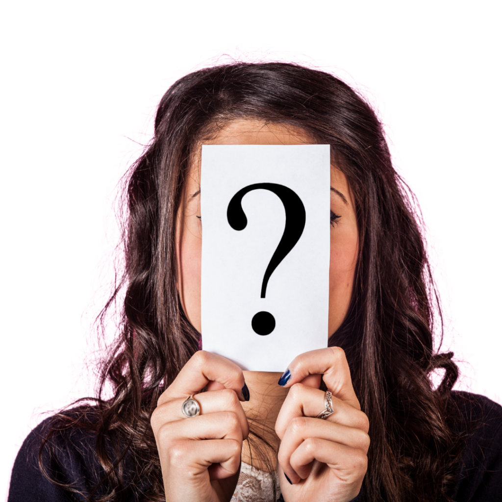 A woman holds a question mark in front of her face