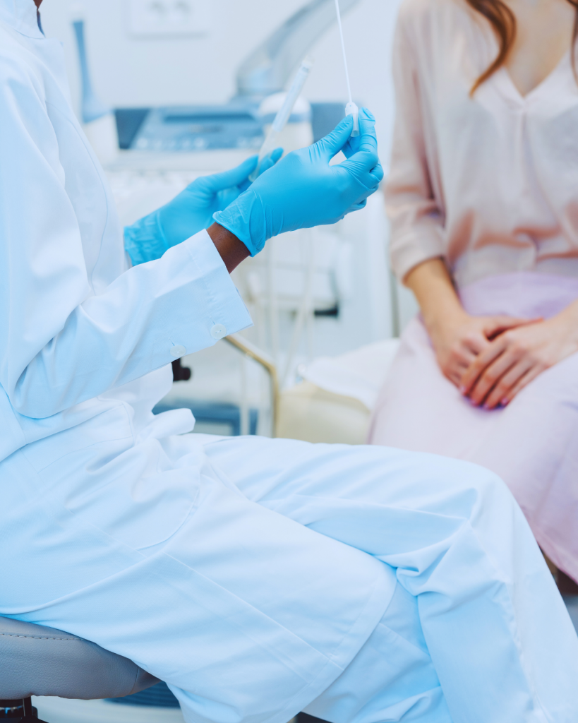 A doctor sits with a patient