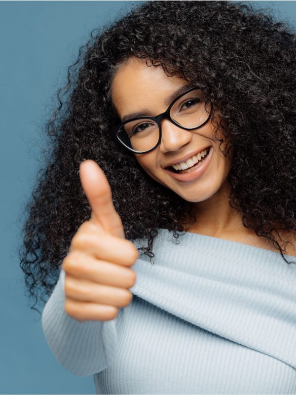 A teen gives a thumbs up