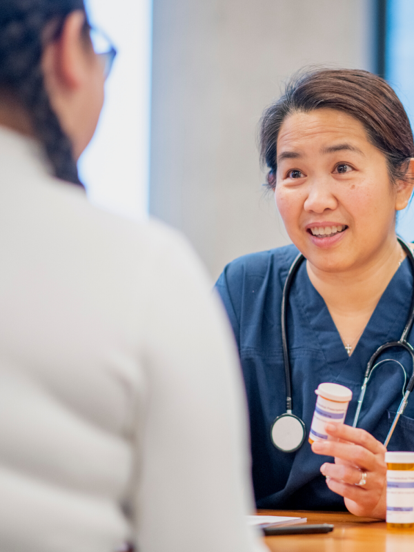 A health care provider talking to a teen patient